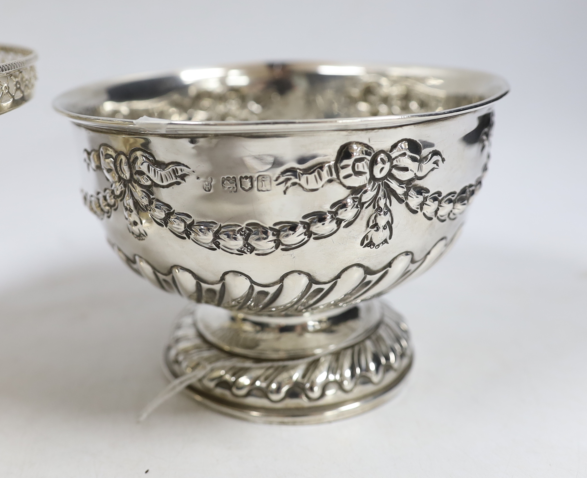 An Edwardian small repousse silver rose bowl, Charles Stuart Harris & Sons London, 1904, diameter 13.7cm and a later larger silver pedestal bowl, 15.3oz.